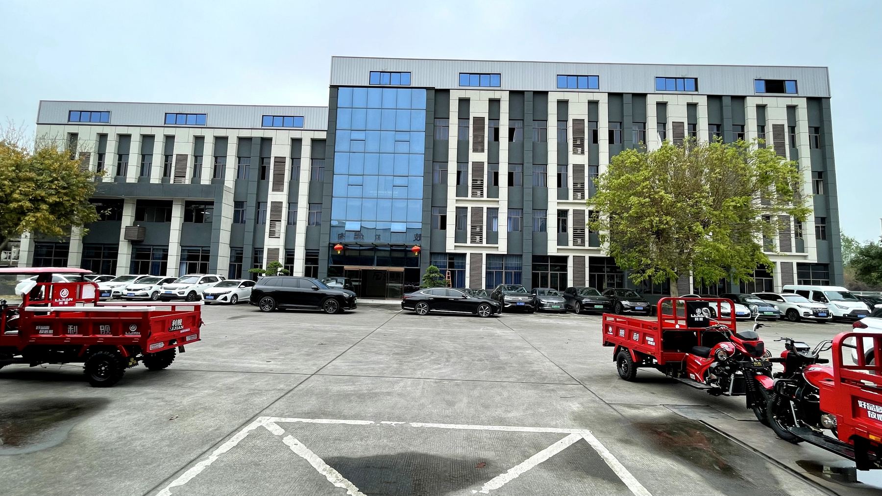 Company building and tricycles in the front yard