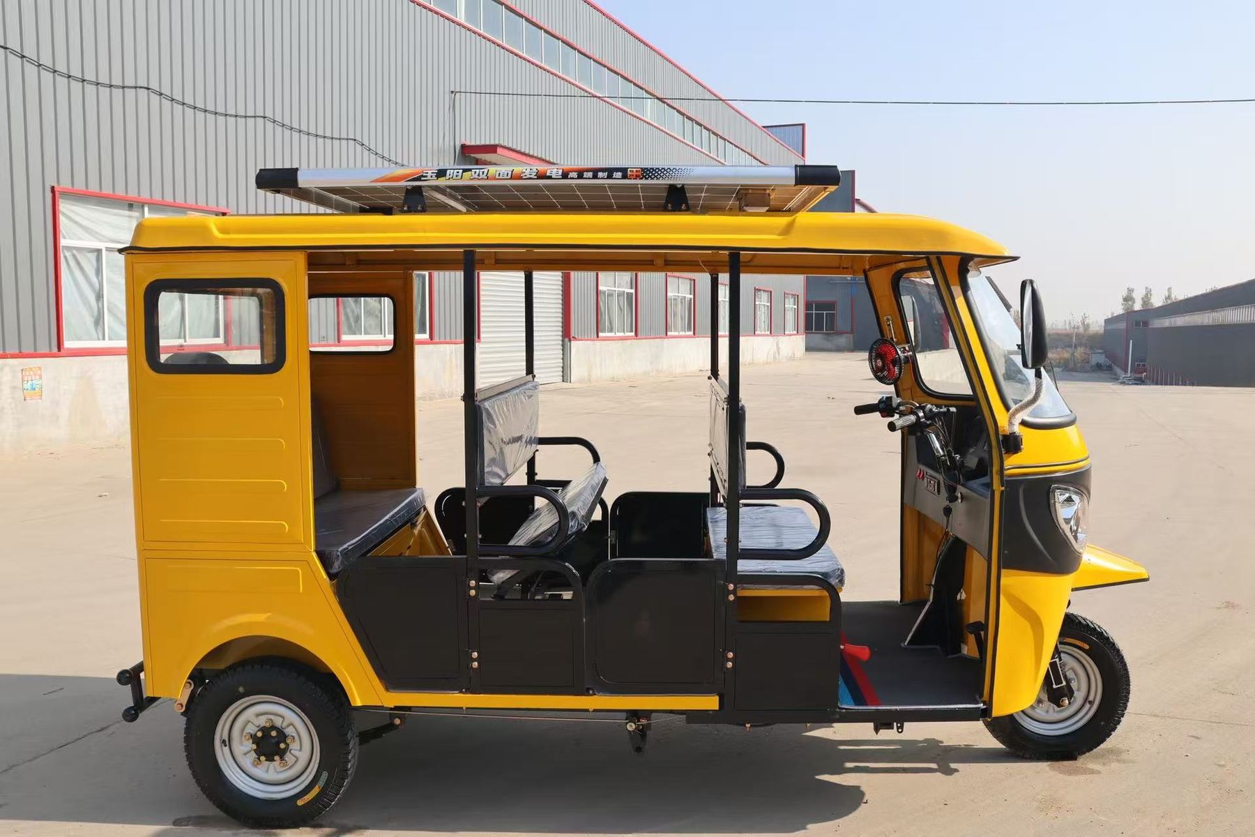 Yellow passenger electric tuk-tuk side view